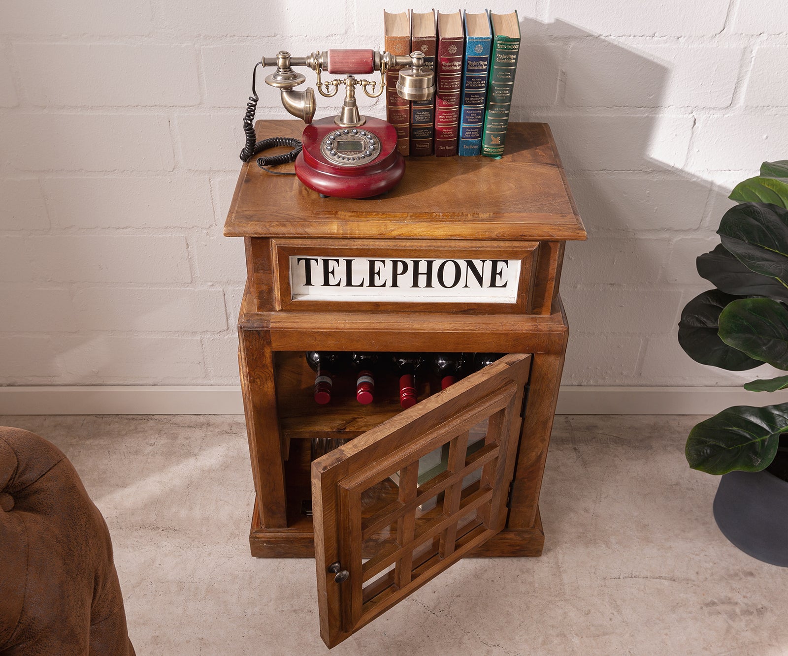 Rustic wooden side cabinet with glass-pane door, antique telephone, living room setup.