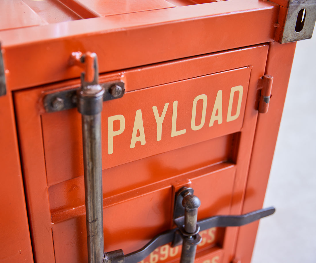 Close-up of an orange cargo container with 'PAYLOAD' text.