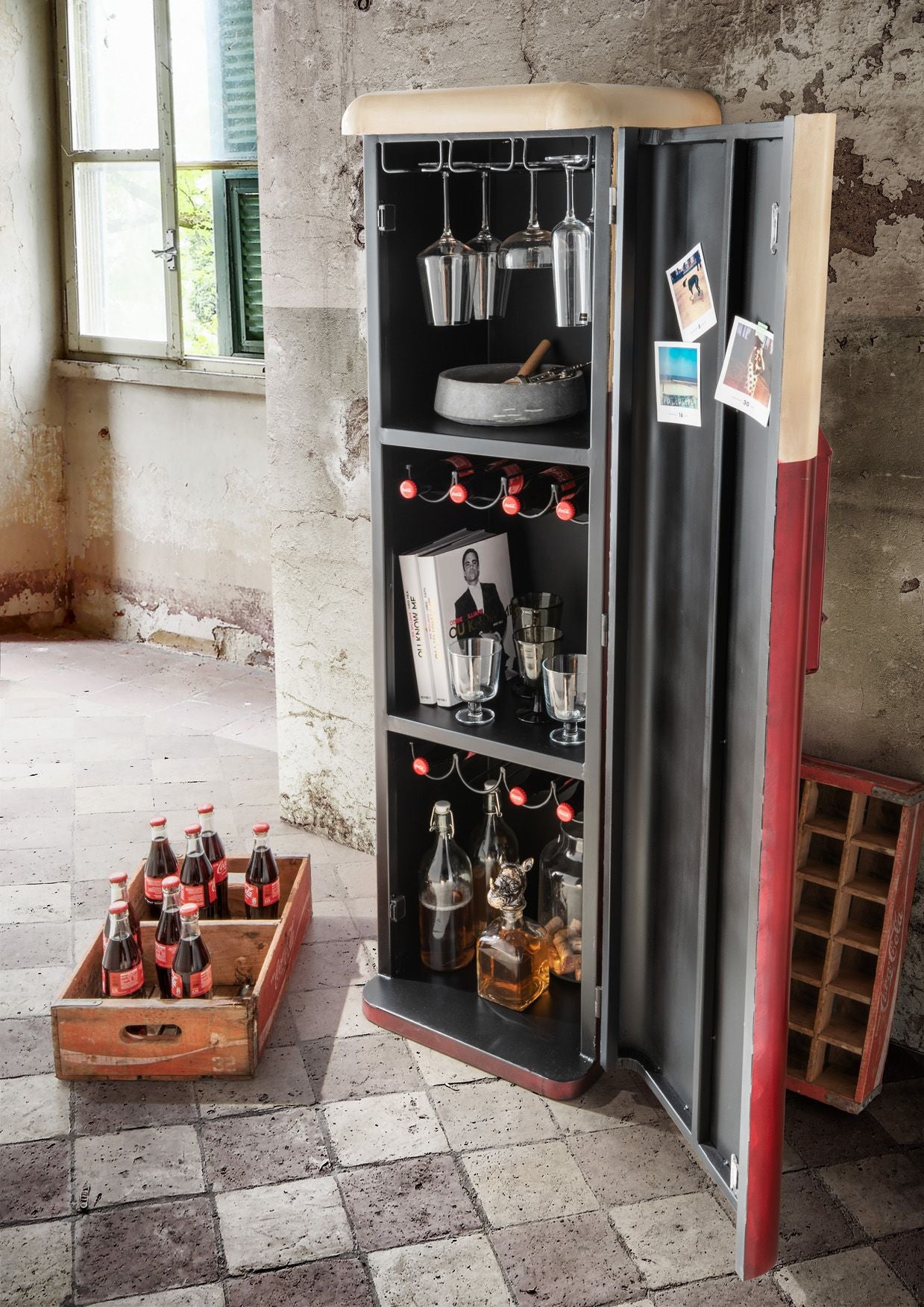 Vintage-style bar cabinet with shelves and bottles in a rustic setting
