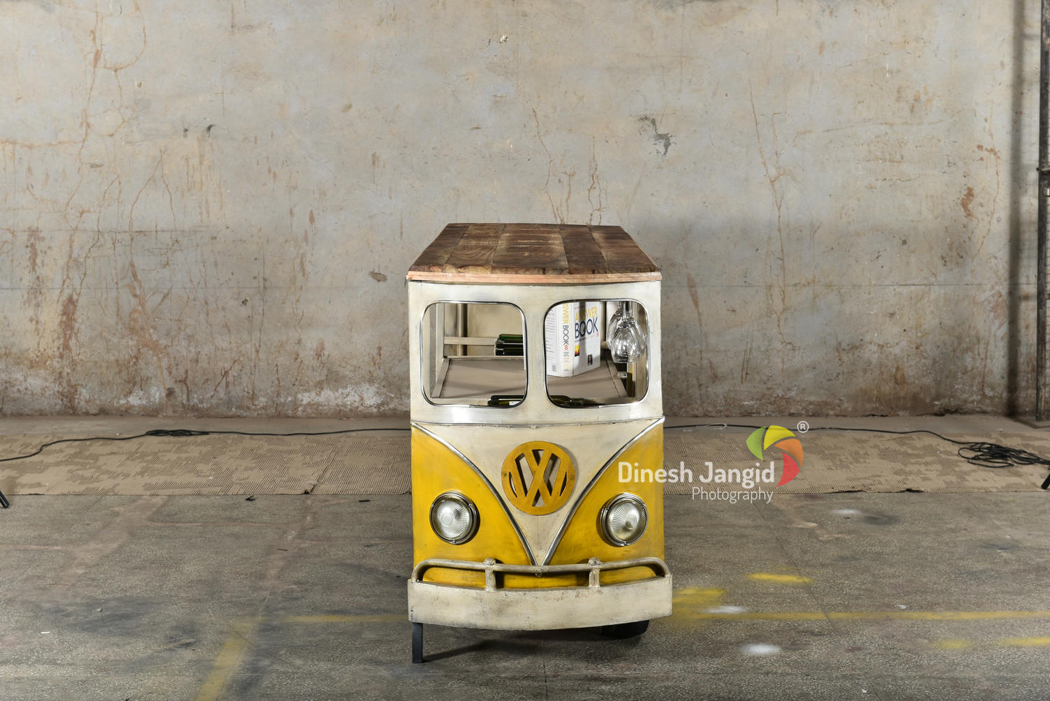 Retro yellow van bar with a wooden tabletop and wheels.