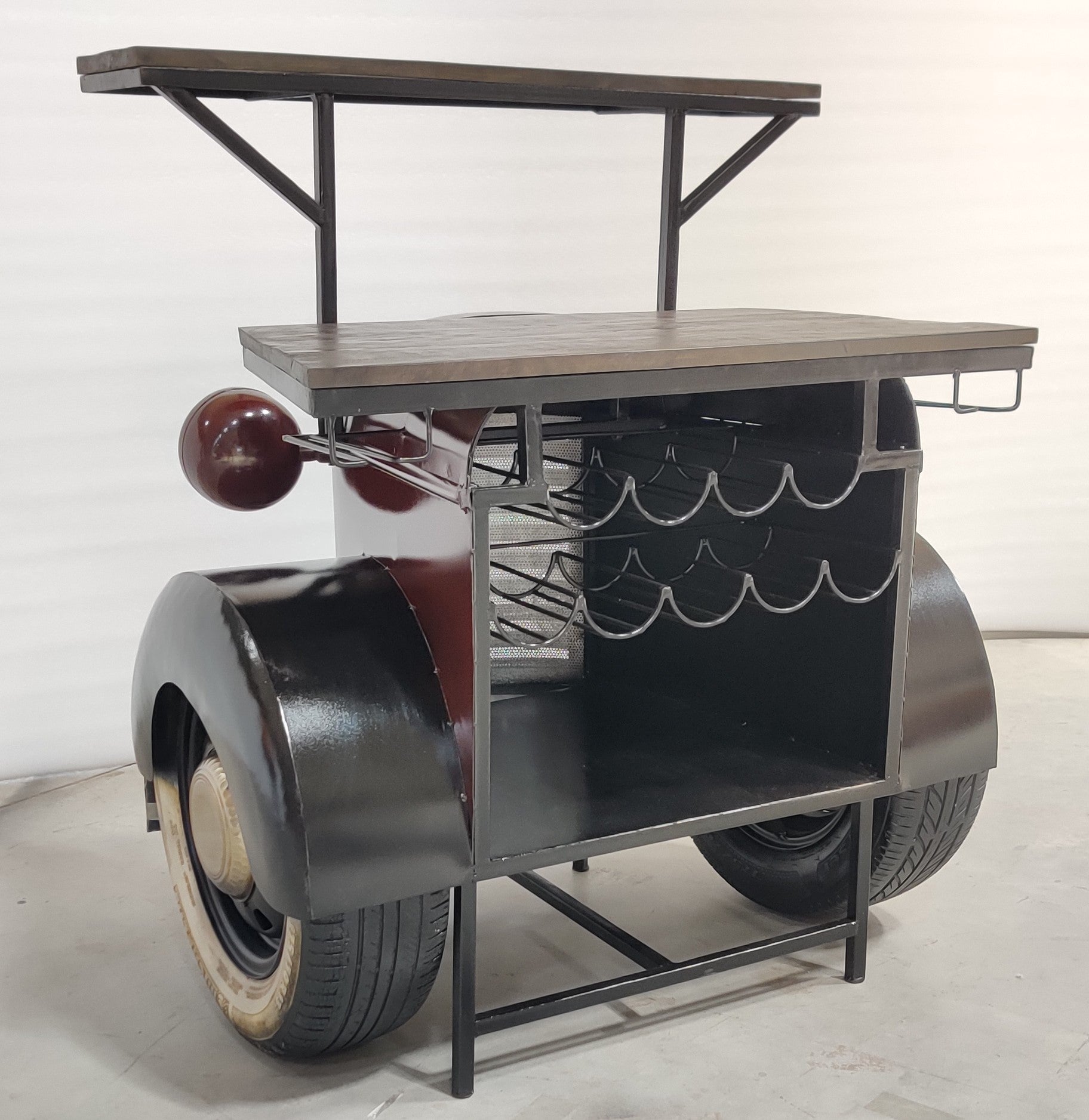 Vintage truck-inspired bar counter with headlights and a metal roof.