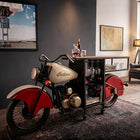 Glider Bike Bar Counter with a vintage motorcycle front, solid wood countertop, hanging wine glass rack, bottle storage shelves, and metal frame with wheels.