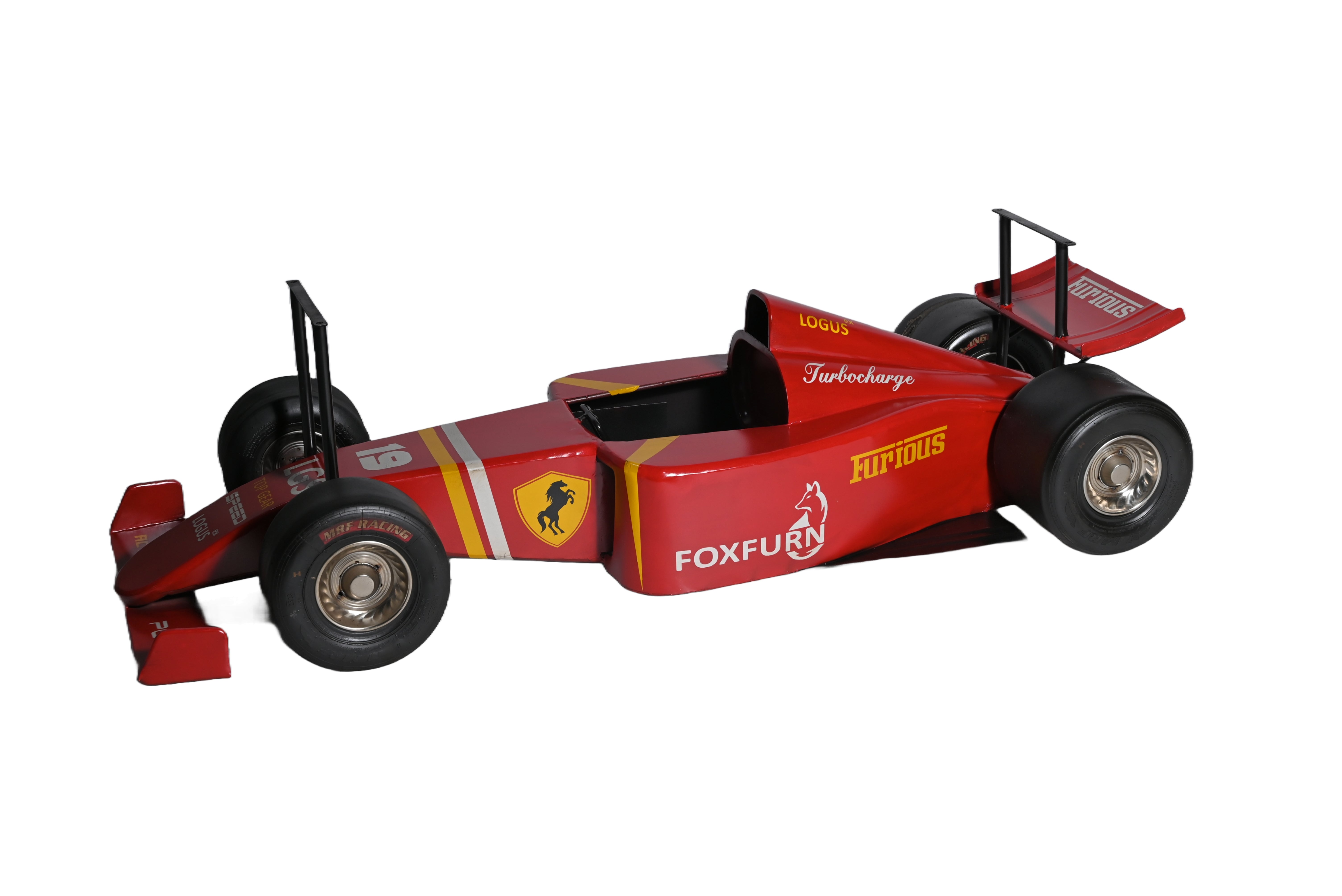 Coffee table shaped like a red race car with detailed wheels.