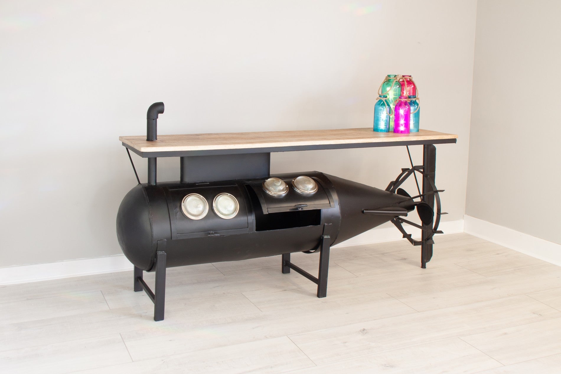 Industrial console table with a torpedo-shaped base and wooden top